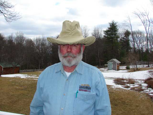 Cyrus Cy Klopps shows the front view of the Waterproof Hat Cover in tan.